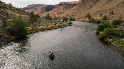 Fishing boat rows down Deschutes River.