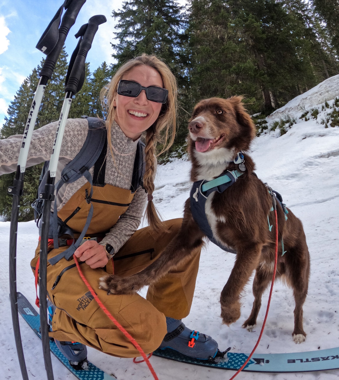 chrissi skis with her dog.