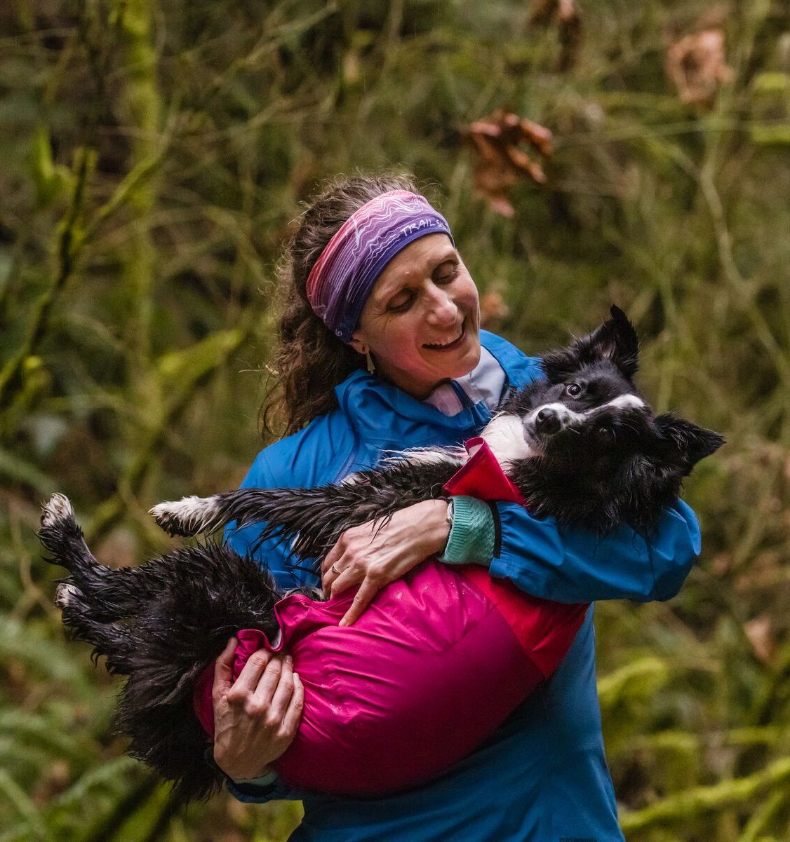 Krissy holds PD - wearing a sun shower raincoat - in her arms.
