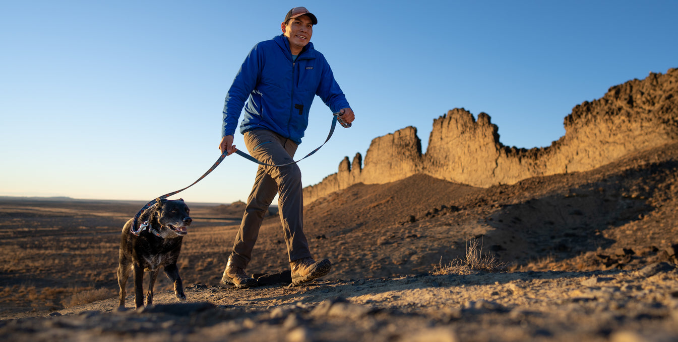 Vernan Kee walks with one of his adopted dogs in the Navajo Nation. 