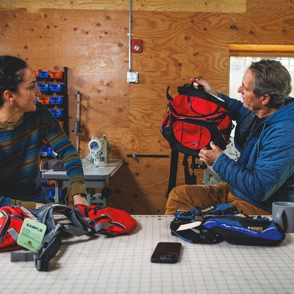 Cristina and PK sit in the R&D room to chat packs.