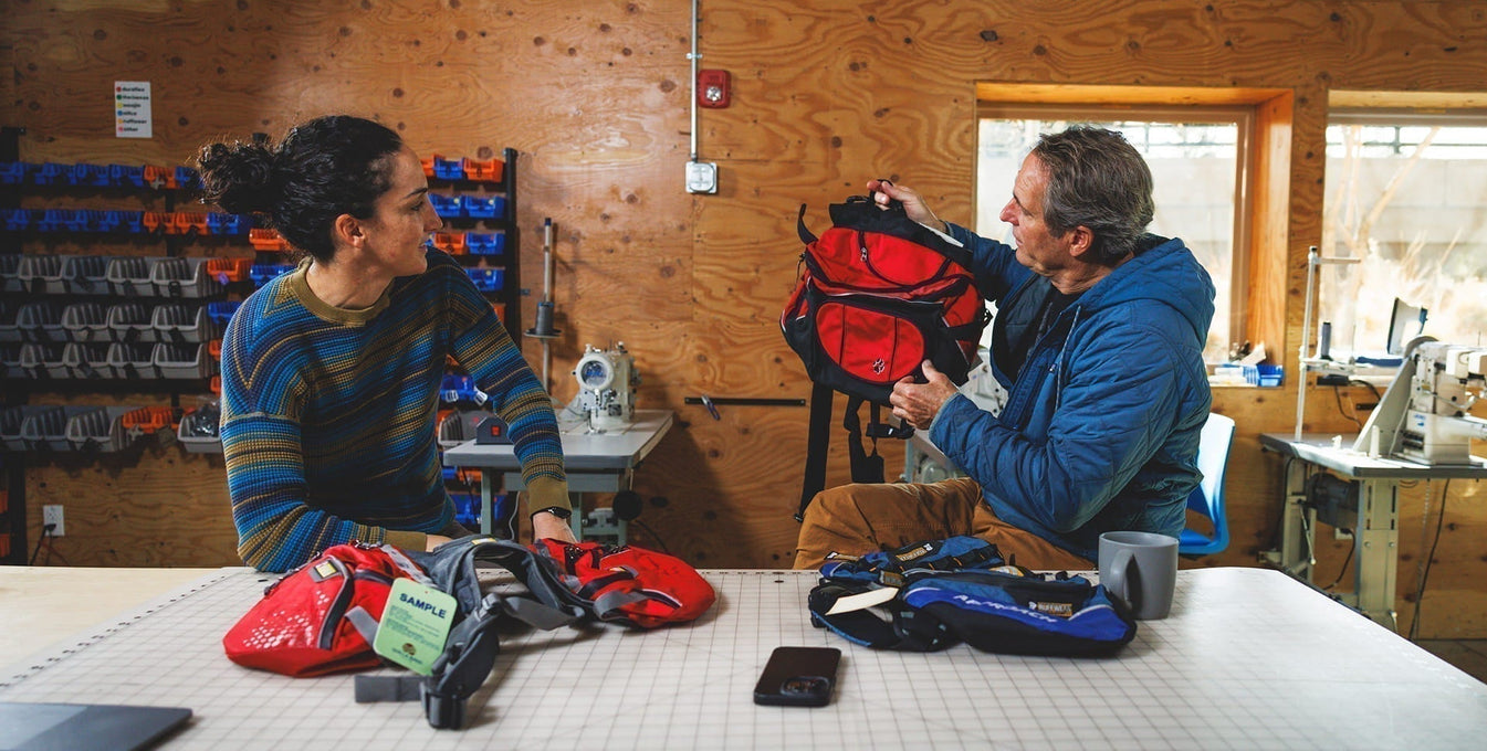 Cristina and PK sit in the R&D room to chat packs.