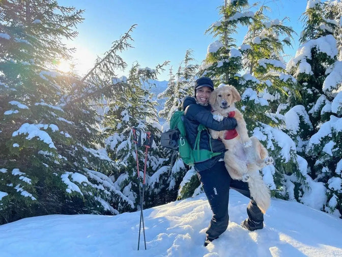 Chris holds up big Sammy on a snowy hike.