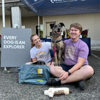 Two humans with dog at RAD Event.